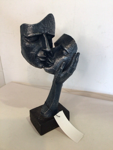 Gray Resin Faces Statue